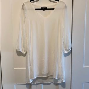 White shift dress with slits in sleeves